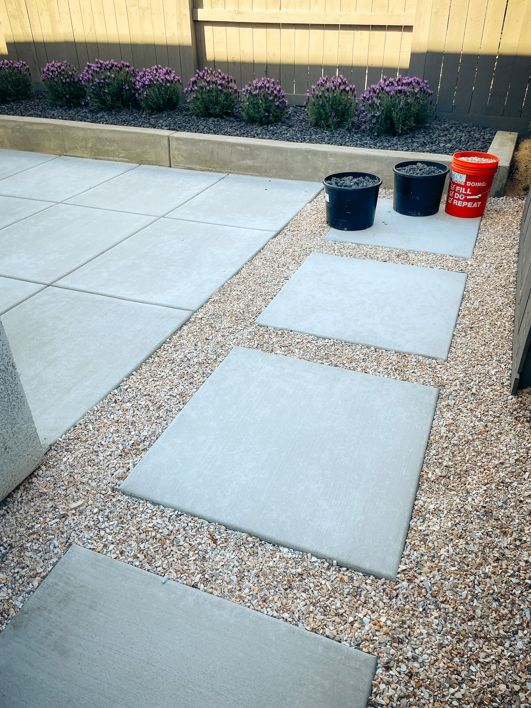 Finished modern paver patio with a decomposed granite path and a lavender border, built by A&F Landscaping